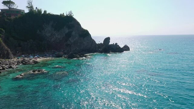Aerial view of sea and rocky beach in Marinella Di Zambrone on a sunny summer day in Calabria, Italy