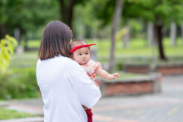 A Taiwanese couple in their 20s and their 7-month-old baby celebrate a birthday in a vast green park in Yilan County, Taiwan.