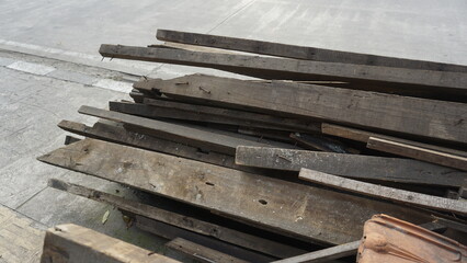 Obsolete piles of wood placed on the side of the road to be transported by transport vehicles
