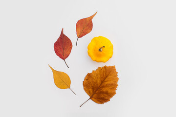 Autumn holiday frame composition with pattern made of leaf, punpkins, dried orange, pine cone on...