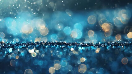 Glittering blue bokeh lights on a dark background, creating a sparkling and magical atmosphere with a wintery feel.