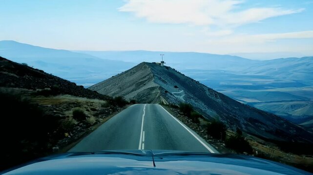vehicle pointofview shot captures thrilling drive south face iconic Mont Ventoux Provence breathtaking scenery southern France highquality 4K mountain nature road arid asphalt