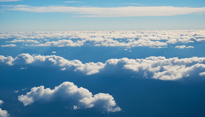 Fototapeta premium blue sky with white clouds. The sky is clear and bright, and the clouds are scattered throughout the sky. Scene is peaceful and serene, as if the viewer is looking up at a beautiful day