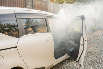 Smoke is coming from inside the car. 