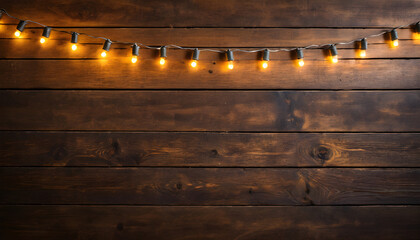 Naklejka premium Rustic wooden floor with glowing Christmas string lights draped along