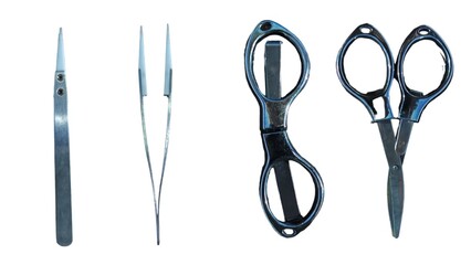 A set of metal grooming tools on a white background, including tweezers and folding scissors.