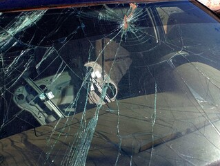 The windshield of the car is broken after the collision. The topic of damaged cars after traffic accidents.