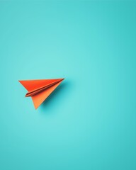 A vibrant orange paper airplane resting on a blue background, symbolizing playfulness, creativity, and freedom.