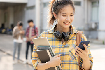 Portrait beautiful Asian woman student. Smile girl happy study. Use phone read ebook in college...