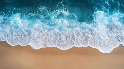 Soft ocean wave gently rolling onto a sandy beach, capturing a peaceful seaside background with clear blue water and golden sand