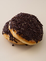 Two donuts with chocolate sprinkles on top