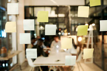 Sticky note, night and office with blur for reminder, schedule planning or tasks on agenda at office. Paper, stickers or post with glass board for brainstorming, ideas or mind map at modern workplace