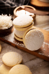 Alfajor. A traditional dessert popular in Latin American, it consists of two cookies joined together with dulce de leche forming a sandwich, covered with powdered sugar, grated coconut or chocolate.
