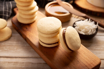 Alfajor. A traditional dessert popular in Latin American, it consists of two cookies joined together with dulce de leche forming a sandwich, covered with powdered sugar, grated coconut or chocolate.