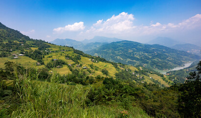 Fototapeta premium Landscape with green and yellow rice terraced fields and cloudy sky in North Vietnam