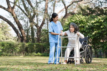 Fototapeta premium Elderly Woman in Rehabilitation with Caregiver Assistance Outdoors in a Park Setting