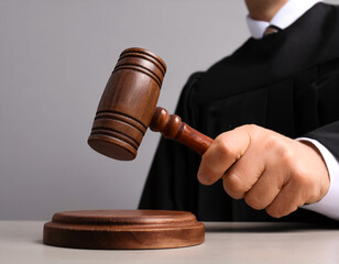 a Man Judge with gavel at wooden table indoors, closeup. Criminal law