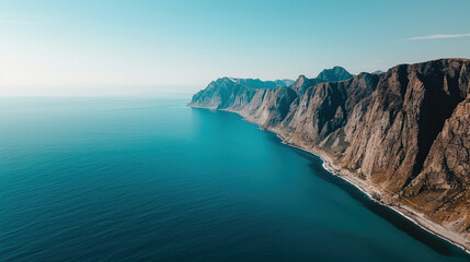 Obraz premium Aerial view of Lofotens deep fjords showcasing steep cliffs and tranquil waters. stunning landscape evokes sense of peace and natural beauty