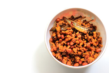 Indonesian dish dried tempeh, made from tempeh or soybeans cut into small pieces, cooked with chili, soy sauce and anchovies, isolated on white background