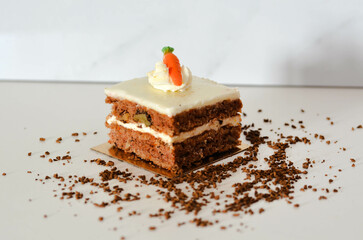 Indulge in a moist carrot cake with creamy frosting, topped with a cute fondant carrot
