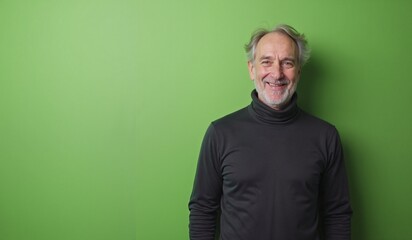 Obraz premium Senior man with cheerful smile posing against bright green background with copy space