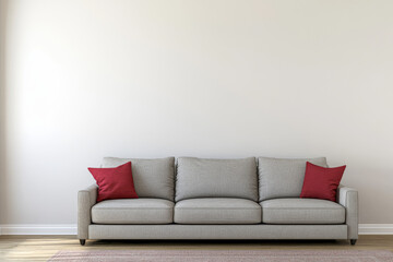 Cozy gray sofa with red pillows in a minimalist living room setting during daylight