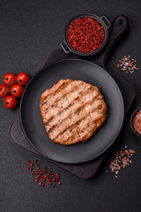 Juicy grilled beef or pork steak with salt, spices and herbs