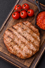 Juicy grilled beef or pork steak with salt, spices and herbs