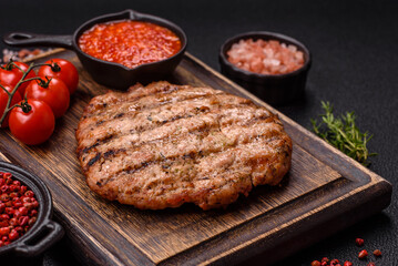 Juicy grilled beef or pork steak with salt, spices and herbs