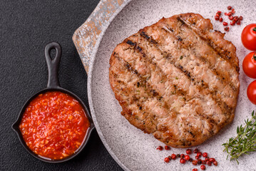 Juicy grilled beef or pork steak with salt, spices and herbs