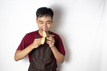 teenage bartender focused on smelling the aroma of peeled bananas