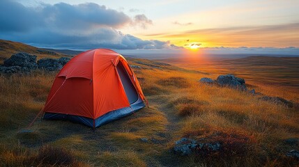 Obraz premium A lone red tent sits on a grassy hill at sunset in Iceland.
