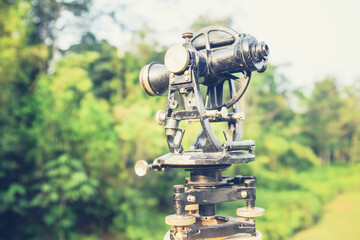 ole theodolite at jungle using for land survey by surveyor