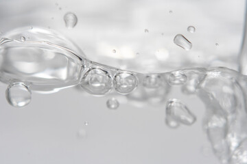 Empty background with bubbles in slight blur at high magnification. Background with close-up of drinking water in soft focus.