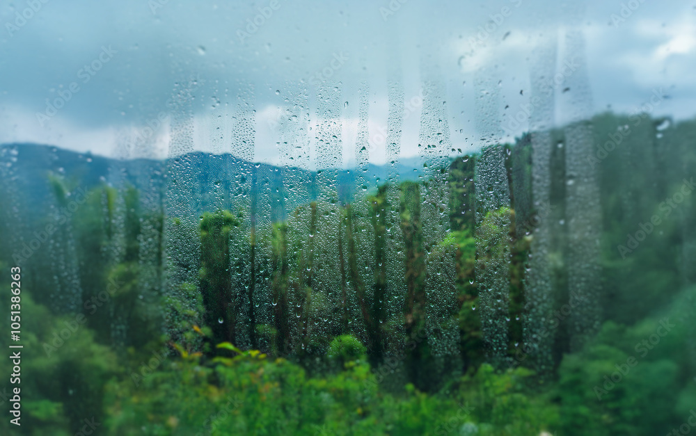 Poster A view of a mountain range through a rain-streaked window.