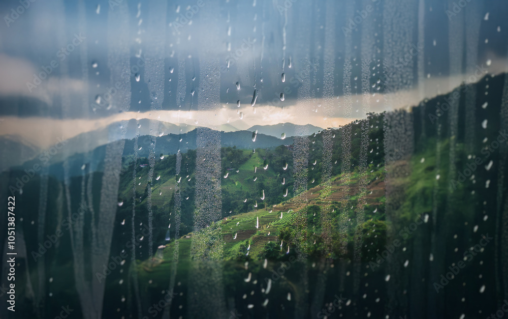 Poster a view of rolling hills and a stormy sky, seen through a window covered in raindrops.