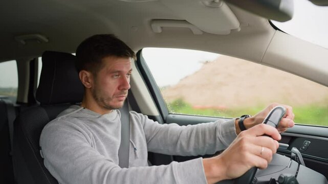 Tired man falling asleep while driving car on highway road. Sleepy male driver closes his eyes and lose concentration. Dangerous driving