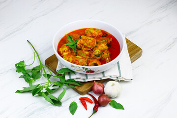 Ayam Rica-Rica, traditional Indonesian hot and spicy braised chicken. White marble background, selected focus.