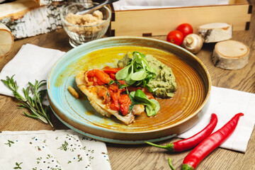 White fish with stewed vegetables and broccoli puree. Cafe, lunch.