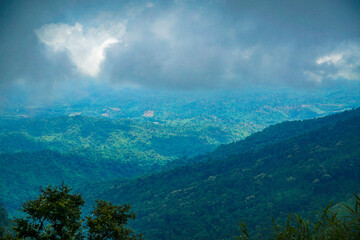 A misty mountain landscape with lush greenery.