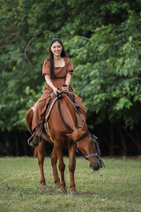happy woman riding horse on meadow field