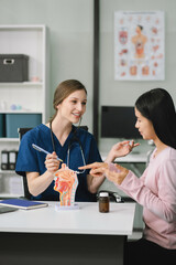 Female doctor and patient are talking and consulting at the table in a medical clinic or hospital...