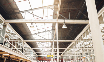 Office, roof and beams with creative warehouse, company and startup with business and storage space. Building, architecture and industrial workspace with metal, lights and decor below at job site