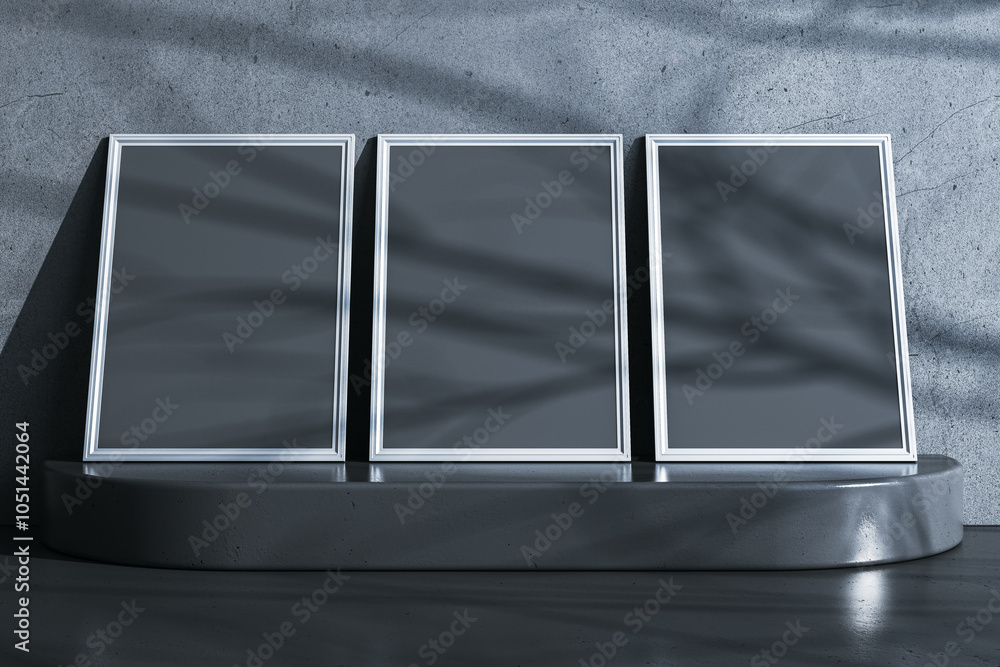 Poster three empty black picture frames on pedestal. gray concrete wall background. mock up concept. 3d ren