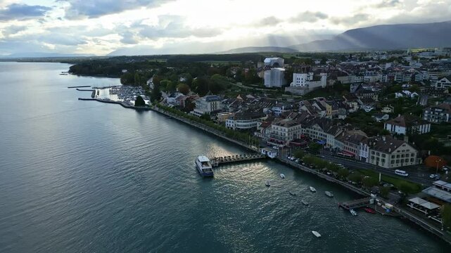 Establishing shot of Nyon with Lake Geneva and castle in Canton of Vaud Switzerland