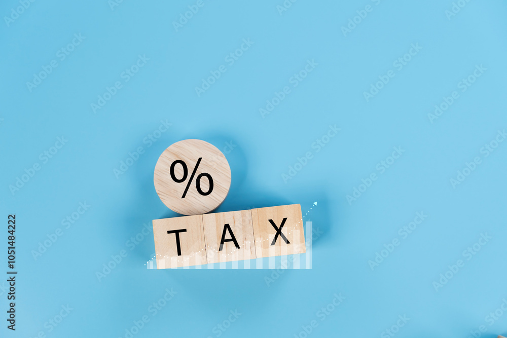 Poster tax wording on wooden cube block array on coins stacking with technical and investment graph chart