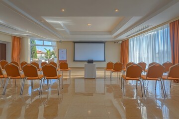 Empty conference room with projector screen and orange chairs