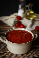 fresh tomato soup in a bowl. on a wooden table. food