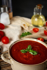 fresh tomato soup in a bowl. on a wooden table. food