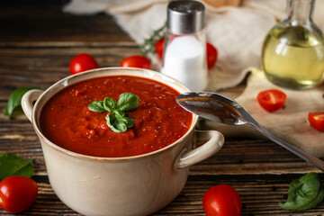 fresh tomato soup in a bowl. on a wooden table. food
